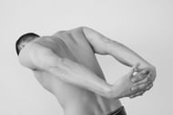 Standing backbends are a gentle way to stretch your spinal column (Image via Pexels/Daria Liudnaya)